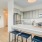Model kitchen at our apartments in Arlington, VA, featuring white countertops and stainless steel appliances.