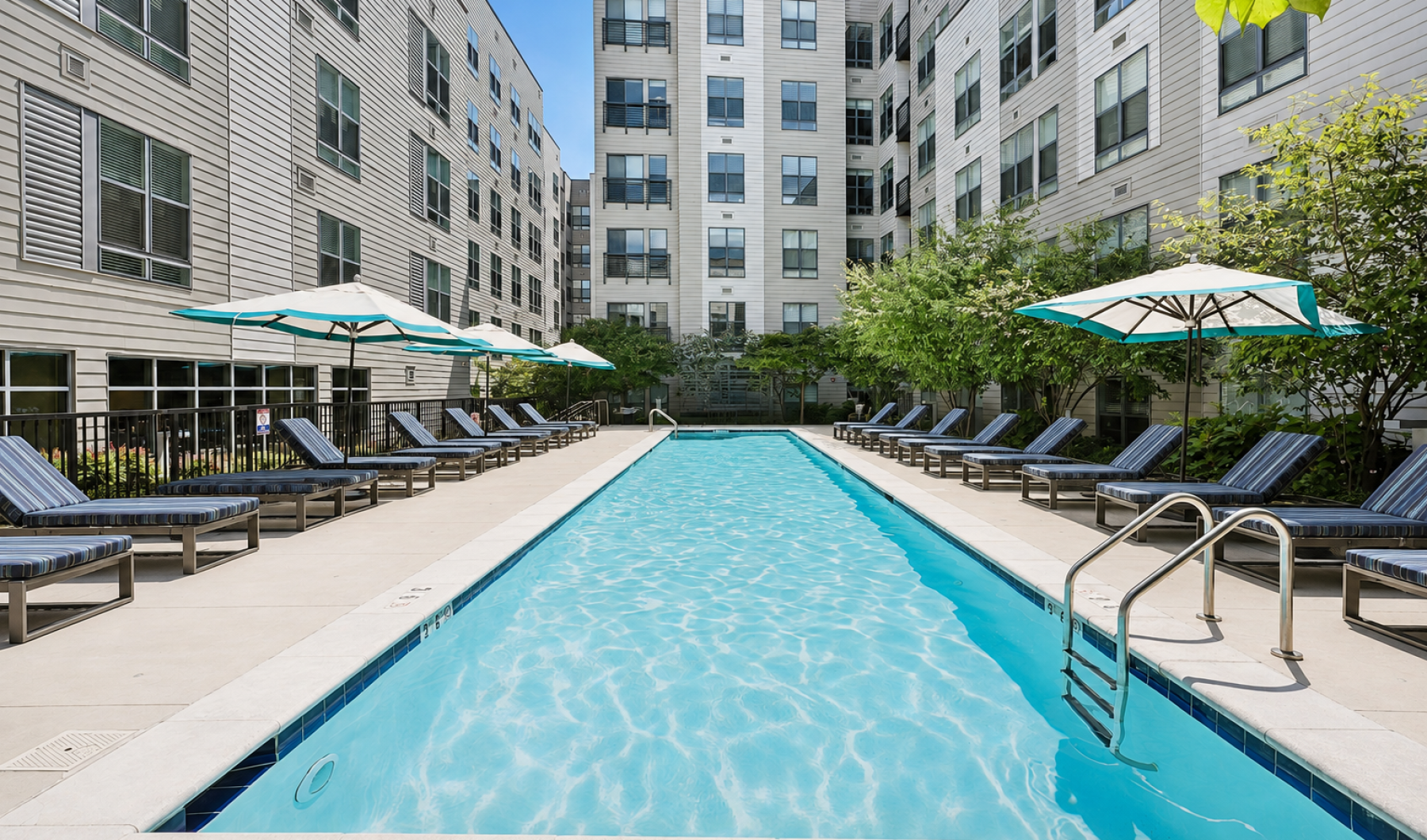 Outdoor resort-style swimming pool and sun lounge deck at Centro Arlington apartments
